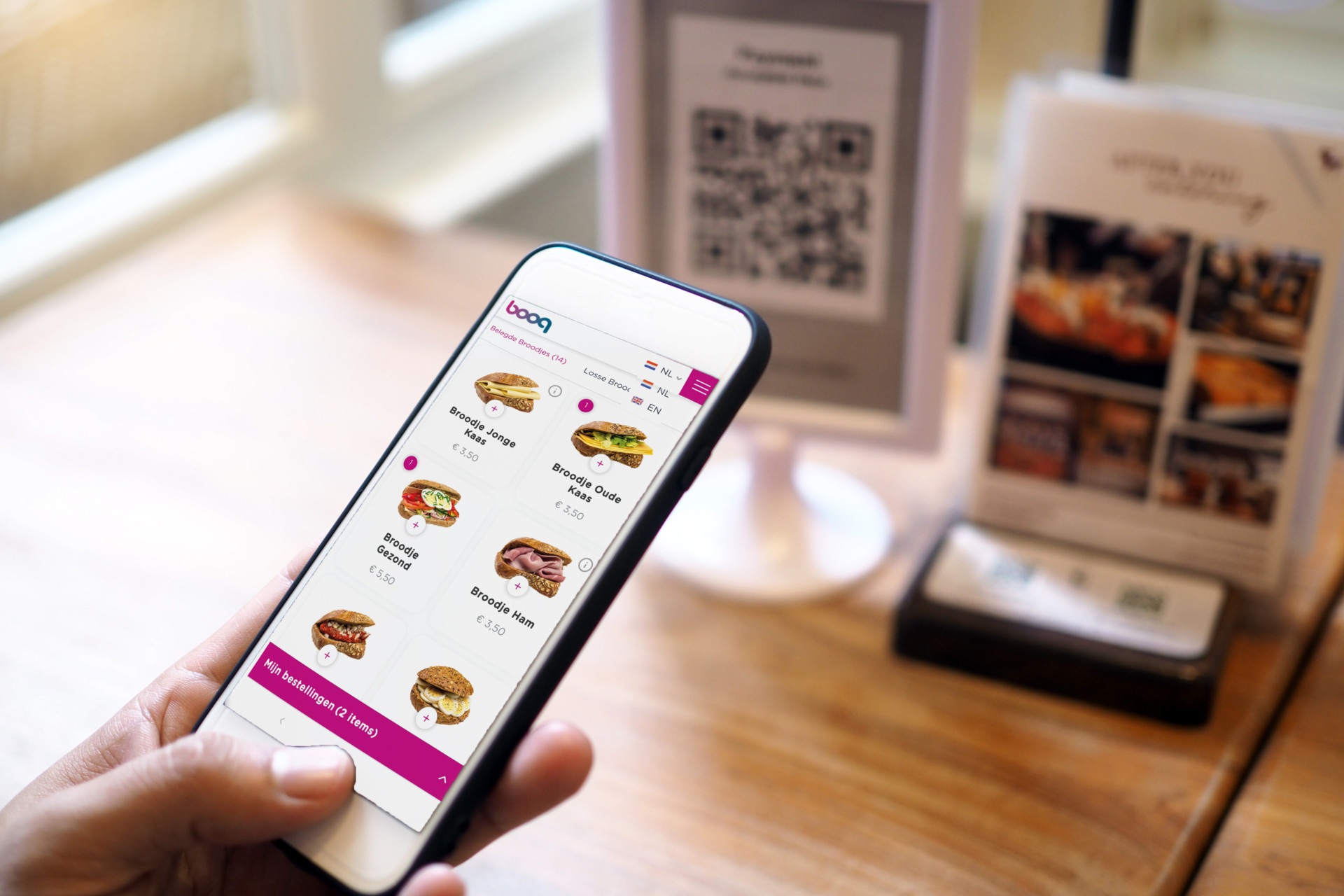 Hands use the phone to scan QR codes to accumulate points in restaurants.